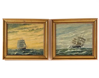 May include: Two framed paintings of sailing ships at sea. The paintings are in gold frames and depict ships with billowing sails on choppy water under cloudy skies. The paintings are in a nautical theme.