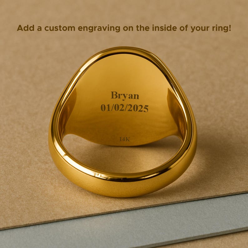 May include: A gold-colored ring with an engraved interior. The engraving reads "Bryan 01/02/2025". The ring is marked "14K" and is set against a neutral background. The text above the ring says, "Add a custom engraving on the inside of your ring!"