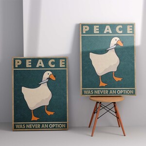 May include: Two posters with a white goose holding a knife in its beak. The posters have a teal background and the text "Peace was never an option".