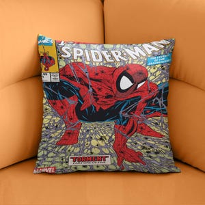 May include: A red and blue Spider-Man comic book cover cushion featuring Spider-Man in a web. The cover text reads "Spider-Man" and "The Legend of the Arachknight". The bottom of the cover reads "Marvel" and "Torment Part One of Five".