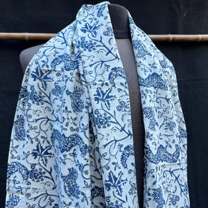 May include: A white ceramic mug with a black handle and the text "But First, Coffee" in a bold, black font. The mug is set against a neutral background, highlighting its simple design.