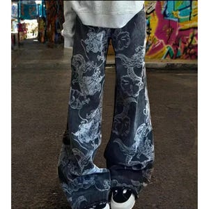 May include: Black wide-leg jeans with a white dragon print.