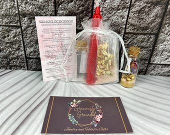 May include: A self-love intention kit with a red candle, dried flowers, and a small glass bottle. The kit includes a card with affirmations and the text "SELF-LOVE INTENTION KIT CREATED BY GRACIOUSLY GROUNDED". The kit is designed for jewelry and holistic gifts.