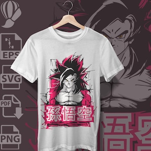 May include: A white short-sleeved t-shirt featuring a graphic print of a spiky-haired character with red accents and the Japanese text 孫悟空 in a pink rectangular frame. The design includes sharp black lines and a bold, stylised illustration.