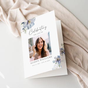 May include: A white card with blue watercolor flowers and a photo of a woman smiling. The text reads "Celebrating the life of Alison Williams May 15, 1983 - June 30, 20XX".