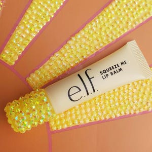 bedazzled elf squeeze me lip glosss. All hand jewled made with love!