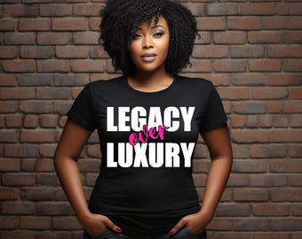 May include: Black t-shirt with the text "LEGACY over LUXURY" in white letters. The word "over" is in pink.