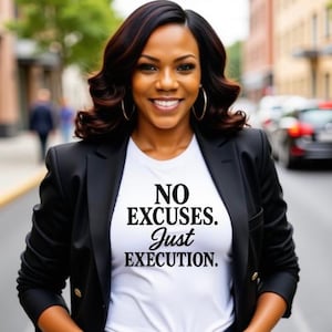 May include: A woman wearing a black blazer over a white t-shirt with the text "NO EXCUSES. Just EXECUTION." printed on it.