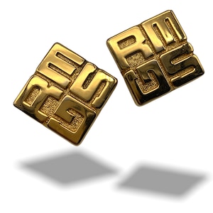 May include: A pair of gold-tone square earrings with a geometric design featuring the letters "4G" on one earring and "4G" on the other earring.
