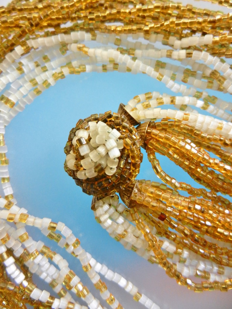 Art.3075 Appealing multi strands old Venetian necklace made of amber and milky white of small seed glass beads