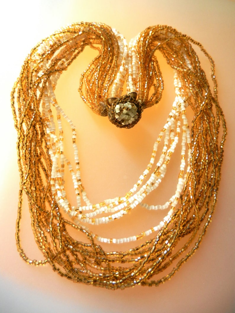 Art.3075 Appealing multi strands old Venetian necklace made of amber and milky white of small seed glass beads