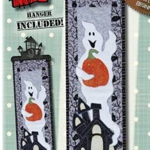 May include: A Halloween-themed fabric panel featuring a white ghost holding an orange pumpkin, with a black haunted house. The panel is 6 inches by 22 inches. The text "Haunt 'n Ghost" and "BEGINNER" are visible.
