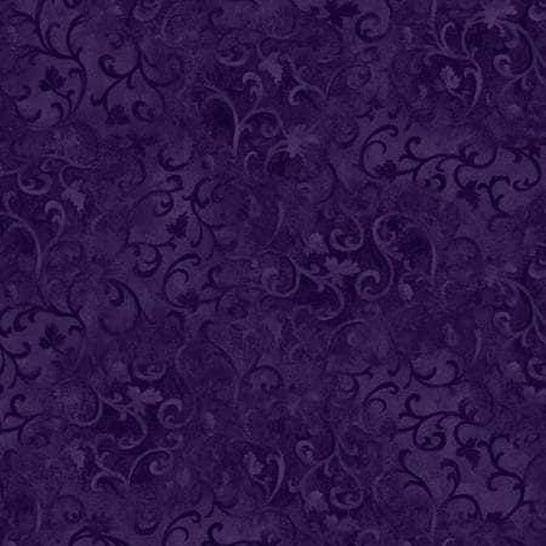 The image is a dark purple fabric with a repeating pattern of swirls and leaves.
