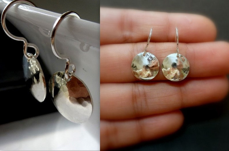May include: A pair of silver dangle earrings with hammered round disc pendants.