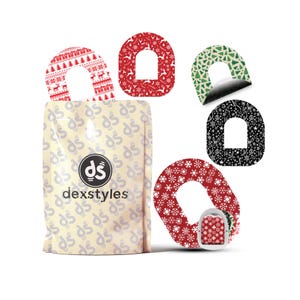 Puede incluir: Un conjunto de productos Dexstyles con diseños variados. Los diseños incluyen árboles de Navidad, copos de nieve y renos en rojo, verde y negro. El paquete tiene el logotipo y el texto de Dexstyles.
