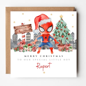 May include: Christmas card with a watercolour illustration of Spider-Man in a Santa hat, beside a Christmas tree and a North Pole sign. The card reads "Merry Christmas to our special little boy" and a name.