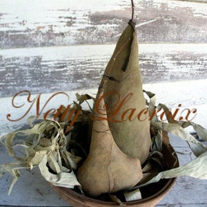 May include: Two brown, dried, leaf-shaped gourds in a wooden bowl with dried leaves and twigs.