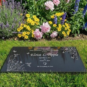 May include: A black granite memorial plaque with the name "Eloise L. Tippie" and dates September 6, 1931 to October 7, 2024. The plaque is decorated with etched butterflies, hummingbirds, and floral designs. The words "Do Everything in Love" are also inscribed.