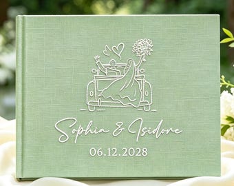 May include: A sage green photo album with a textured fabric cover. The front features a white line-art illustration of a couple in a convertible car, the names "Sophia & Isidore" in script, and the date "06.12.2028" printed in white.
