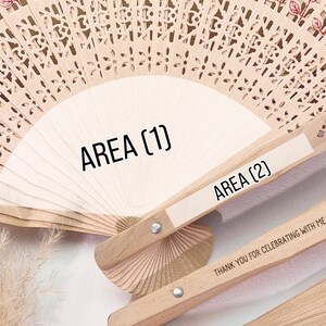 May include: Wooden hand fans with intricate cut-out designs. The fans are light brown with a white area for text. The text on the fan reads "AREA (1)" and "AREA (2)". The fan's handle has the text "THANK YOU FOR CELEBRATING WITH ME".