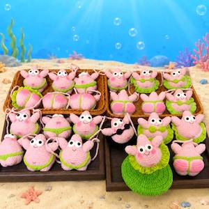 May include: A collection of small, pink, crocheted starfish figures arranged in two rectangular baskets. Each figure features large white eyes, a smiling mouth, and various green or black crocheted clothing items, including bikinis and skirts.