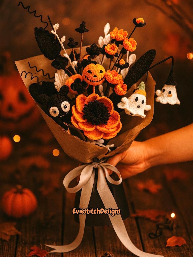 May include: A Halloween-themed crochet bouquet featuring orange and black flowers, a jack-o'-lantern, a ghost, and a bat. The bouquet is wrapped in brown paper and tied with a gray ribbon. The background is a blurred image of autumn leaves and pumpkins. The text 'EvieStitchDesigns' is visible.