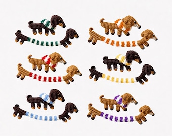 May include: A collection of six sets of crocheted dachshund figures. Each set includes one standing dog and one elongated dog, both wearing scarves in various colours including green, orange, red, yellow, blue, and purple with white accents.