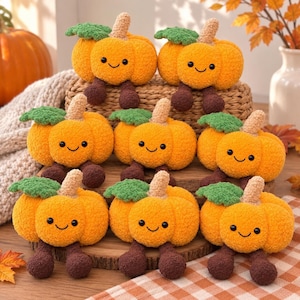 May include: A collection of eight plush orange pumpkins with fuzzy textures, each featuring a green leaf, a tan stem, and two dangling dark brown legs. The pumpkins have embroidered black eyes and a small smiling mouth, arranged in a group.
