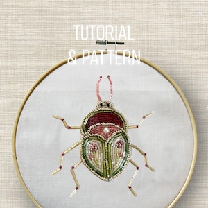 May include: An embroidered insect design on white fabric, held within a wooden embroidery hoop. The insect is crafted with beadwork in green, red, and gold. The text "TUTORIAL & PATTERN" is above the hoop.