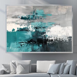 May include: Abstract oil painting in a white frame. The artwork features textured brushstrokes in shades of teal, grey, white, and black. The painting is displayed above a white sectional sofa with several white cushions, creating a modern aesthetic.