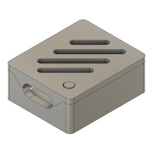 May include: A light gray rectangular object with rounded corners. The top surface has three parallel, elongated openings. A circular indentation is on one side, and a larger, oval-shaped opening is on the side.