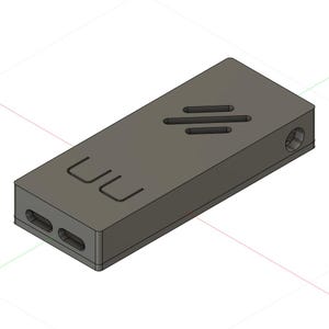 May include: A gray rectangular device with rounded edges. The device has two rectangular openings on one end and a circular opening on the other. The top surface features three horizontal slots and the letters "UU".