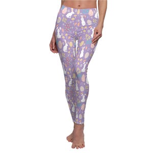 May include: Purple leggings with a pattern of white bunnies, pastel eggs, and flowers.