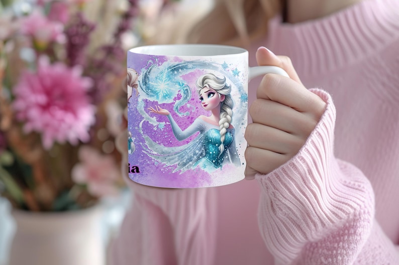 May include: White ceramic mug featuring a watercolor illustration of a princess with a long braid, wearing a blue dress, and surrounded by swirling blue and purple elements. The mug has the name "ia" printed on it.