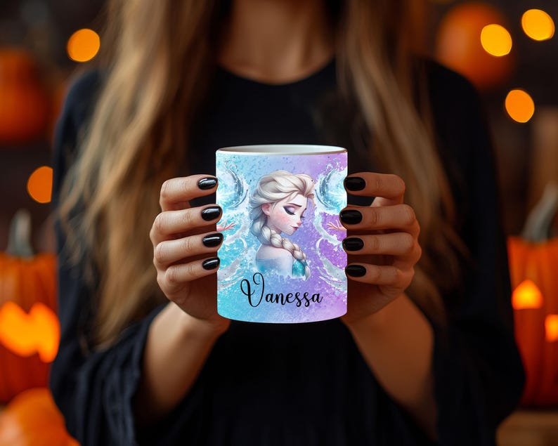 May include: A white ceramic mug with a gradient blue and purple background. The mug features a portrait of a woman with blonde hair and the name "Vanessa" in cursive. The design includes water and ice elements.