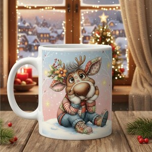 May include: White ceramic mug featuring a cartoon reindeer character in a winter scene. The reindeer wears a colorful sweater, jeans, and sneakers. The background shows a snowy landscape and a Christmas tree. The mug is on a wooden surface.