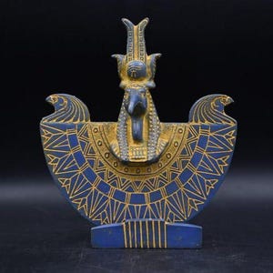 statue of the ancient Egyptian god Thoth with ibis head and upright pharaonic posture.