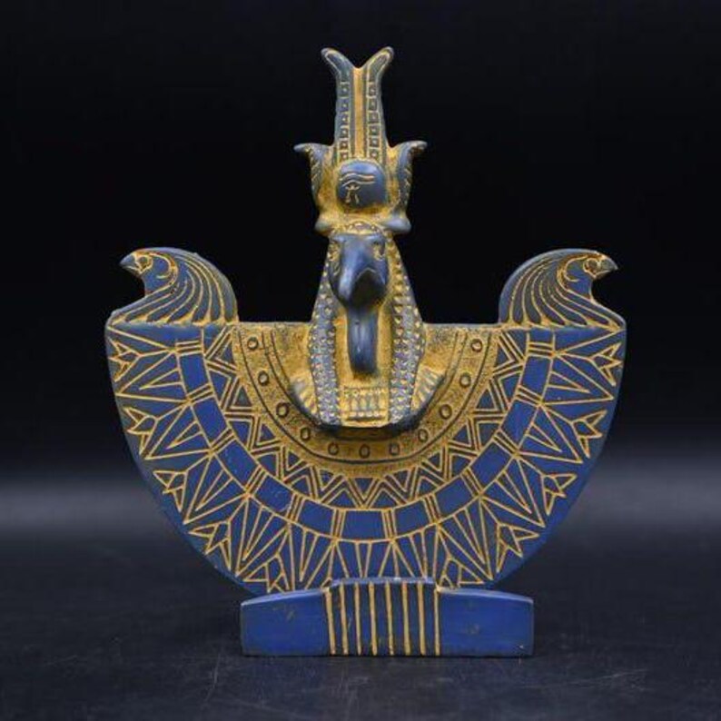 statue of the ancient Egyptian god Thoth with ibis head and upright pharaonic posture.