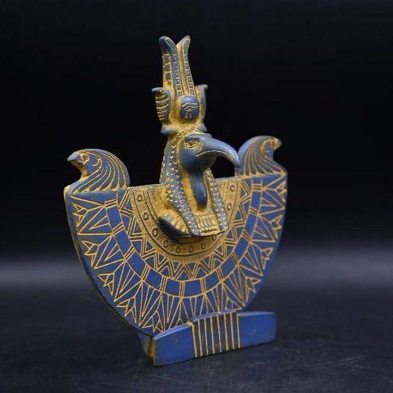 statue of the ancient Egyptian god Thoth with ibis head and upright pharaonic posture.