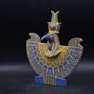 statue of the ancient Egyptian god Thoth with ibis head and upright pharaonic posture.
