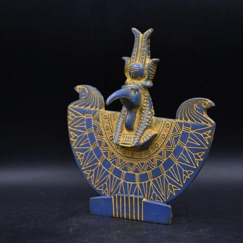 statue of the ancient Egyptian god Thoth with ibis head and upright pharaonic posture.