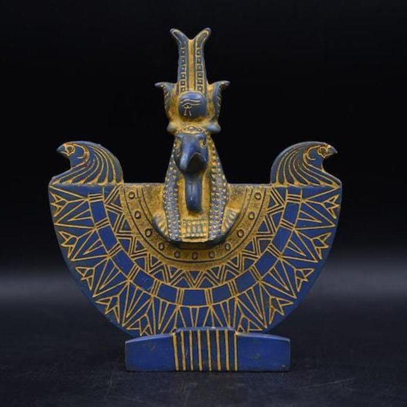 statue of the ancient Egyptian god Thoth with ibis head and upright pharaonic posture.