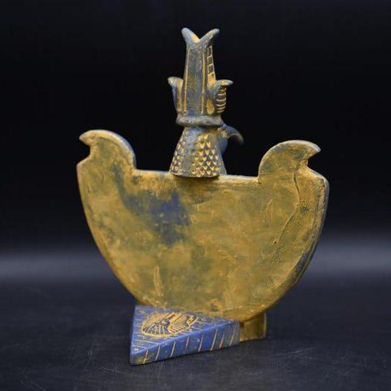 statue of the ancient Egyptian god Thoth with ibis head and upright pharaonic posture.