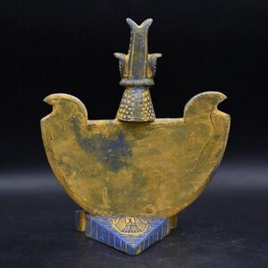 statue of the ancient Egyptian god Thoth with ibis head and upright pharaonic posture.