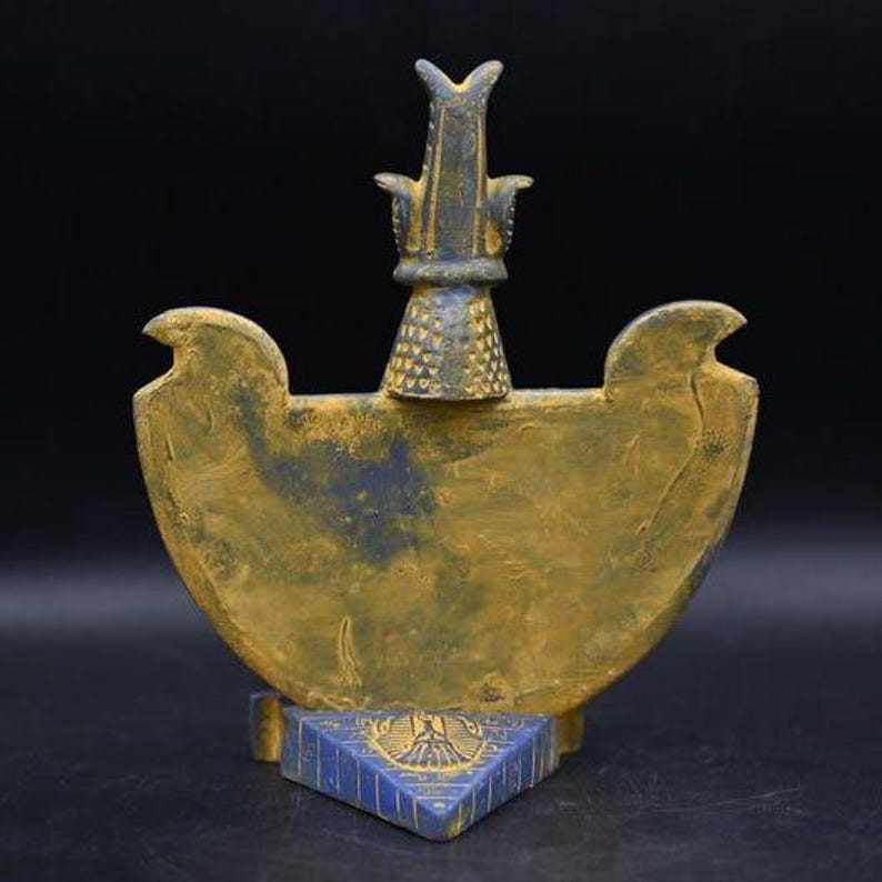 statue of the ancient Egyptian god Thoth with ibis head and upright pharaonic posture.
