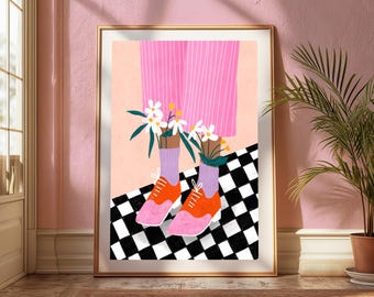 May include: A framed art print featuring a pair of orange and pink lace-up shoes worn with light purple socks. The illustration shows pink pinstriped trousers and white daisy flowers emerging from the socks, set against a black and white checkered floor.