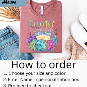 May include: Heather Mauve t-shirt with the text "I Crochet but my favorite hobby is collecting YARN" and colorful yarn ball graphics. The shirt is displayed with blue jeans and white shoes. Instructions on how to order are also included.