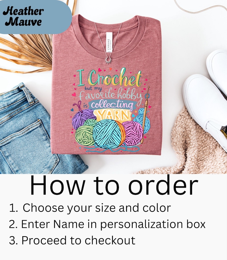 May include: Heather Mauve t-shirt with the text "I Crochet but my favorite hobby is collecting YARN" and colorful yarn ball graphics. The shirt is displayed with blue jeans and white shoes. Instructions on how to order are also included.
