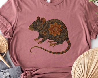 May include: A heather mauve t-shirt featuring a graphic of a rat decorated with intricate dark floral and mandala-style patterns in shades of brown and black. The text "Heather Mauve" is printed in the upper left corner of the image.