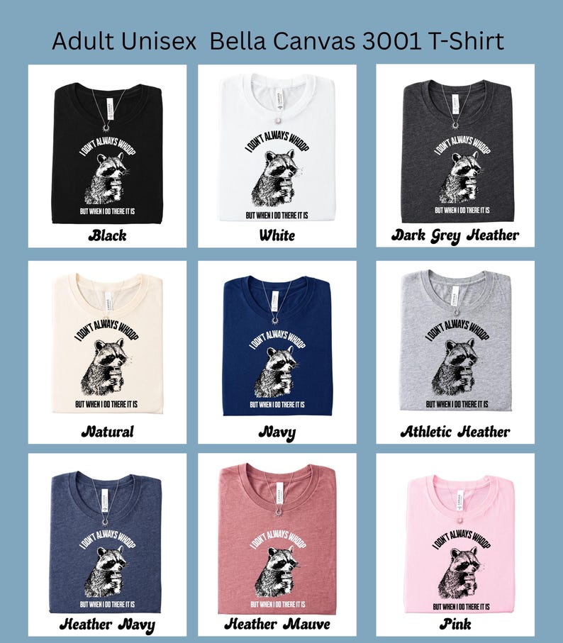 May include: A collection of Bella Canvas 3001 t-shirts in various colors, including black, white, and heather gray. Each shirt features a raccoon graphic with the text "I don't always whoop but when I do there it is."